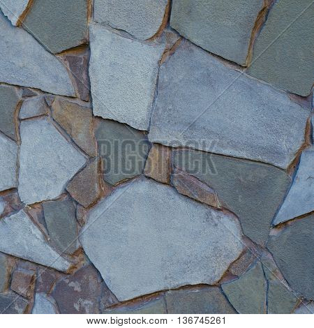 Background of a stone wall cladding texture brown stone bricks