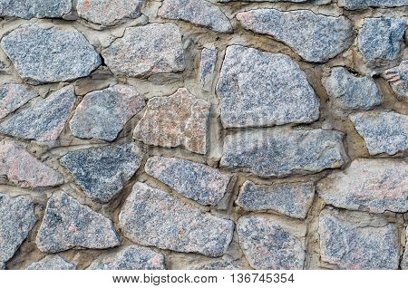 Background of a stone wall cladding texture brown stone bricks