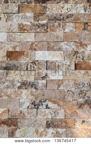 Background of a stone wall cladding texture brown stone bricks