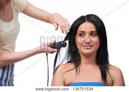Young woman getting hair straightner isolated on white
