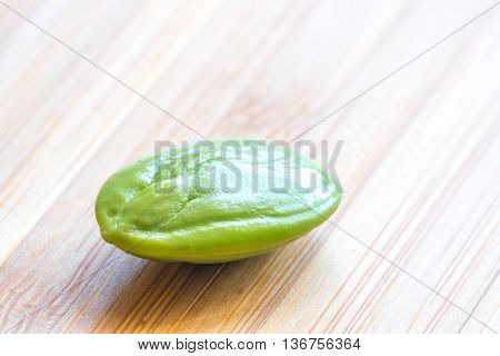 Parkia speciosa ( petai bitter bean twisted cluster bean stinker or stink bean) with white cup and spoon