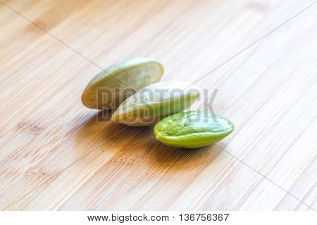 Parkia speciosa ( petai bitter bean twisted cluster bean stinker or stink bean) with white cup and spoon