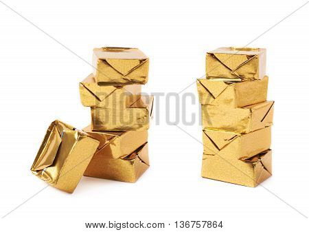 Stack of mulitple bouillon stock broth cubes wrapped in golden foil, composition isolated over the white background, set of two different foreshortenings
