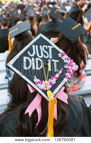 ATHENS, GA - MAY 2016:  A University of Georgia graduate wears a mortarboard that says 