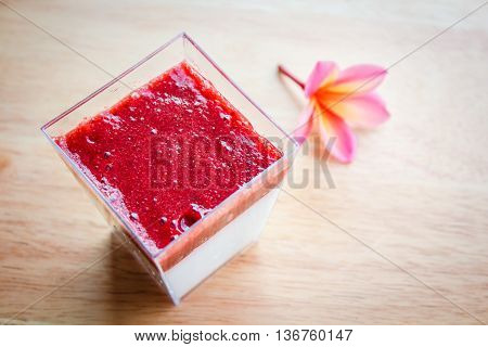 Panna cotta dessert with strawberry sirup, thai style.