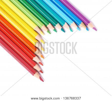 Multiple colorful color pencils composition arranged in a line to form a rainbow gradient, composition isolated over the white background, close-up crop fragment