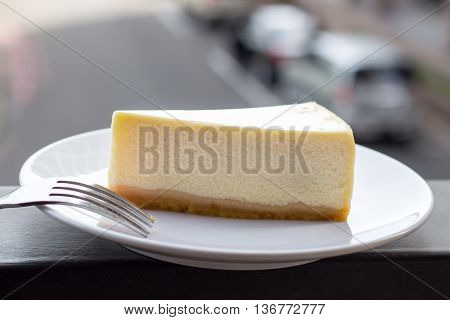 Cheesecake. Slice of Plain New York Cheesecake on white plate.