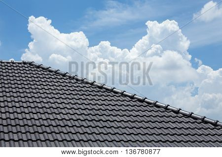 Black Tile Roof Of House With Blue Sky And Cloud Background