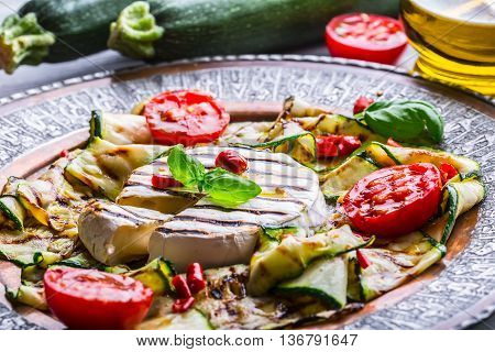 Grill Brie camembert cheese zucchini with chili pepper and olive oil. Italian mediterranean or greek cuisine. Vegan vegetarian food.
