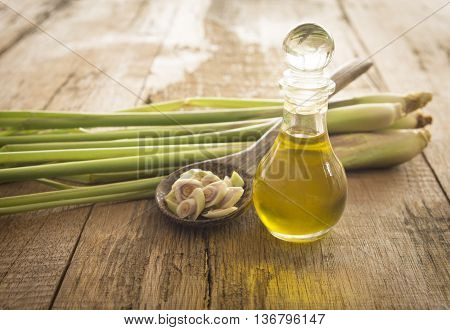 Lemongrass essential oil placed on a wooden table.
