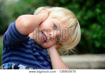 Little girl smile in a green park
