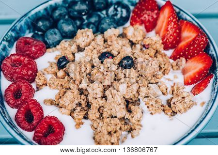 Cereal muesli with fruits in bowl at home. Healthy Food and Dieting concept