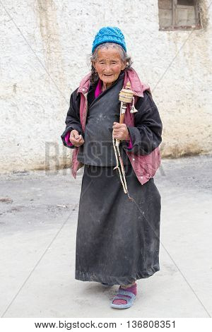 LAMAYURU INDIA - JUNE 15 2015: Unidentified buddhist old women during mystical mask dancing Tsam mystery dance in time of Yuru Kabgyat Buddhist festival at Lamayuru Gompa Ladakh North India