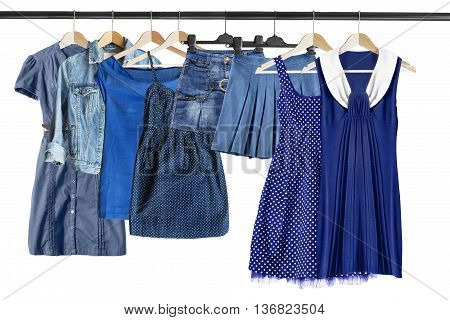 Group of blue clothes on clothes racks isolated over white