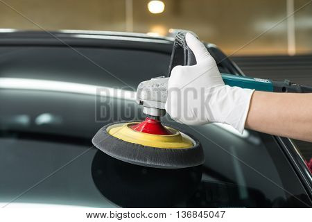 Car detailing series : Closeup of hand buffing windshield