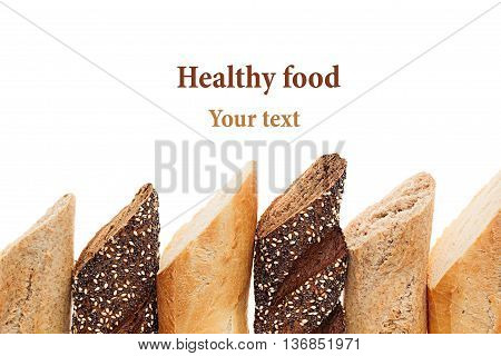 Cut baguette bread of different varieties on a white background. Rye wheat and whole grain bread. Isolated. Decorative frame of bread. Food background. Copy space.