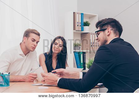 Happy Young Couple On Consultation In Real Eatate Agent