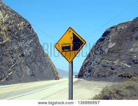 Sign warns of rockslide before canyon on pacific coast highway near Malibu, California