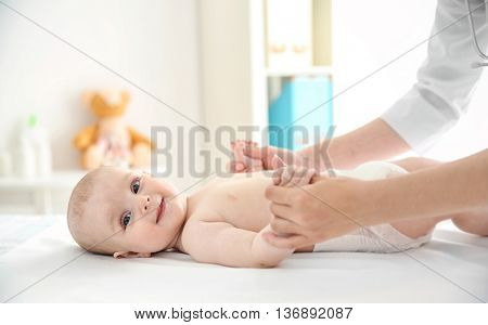 Doctor doing exercises with baby