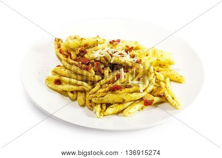 homemade pasta variety called capunti with garlic and oil pickled tomatoes and parmesan cheese specialty from southern Italy on a plate isolated with shadow against a white background selective focus