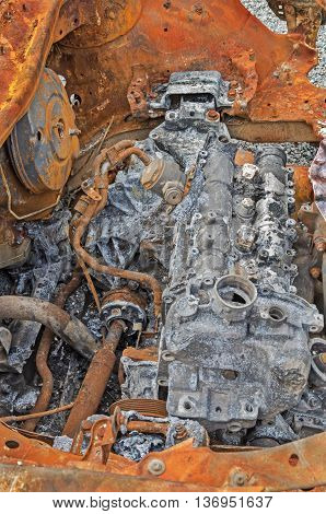Destroyed and rusty car engine in a terrorist explosion and fire