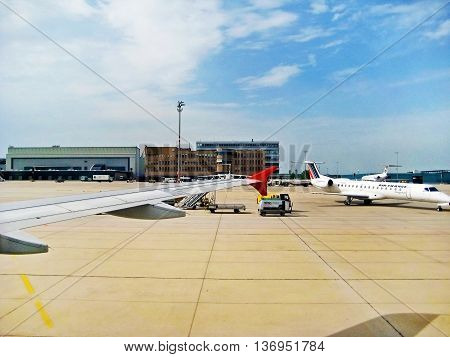 Stuttgart Germany - May 26 2008: Main Terminal labeled with Stuttfart at Airport Echterdingen - view from inside of airplane runway with other planes in front