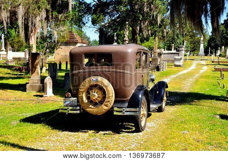 New Bern North Carolina - April 24 2016: Vintage 1929 Model A Ford sightseeing vehicle taking visitors for a tour of historic Cedar Grove Cemetery *