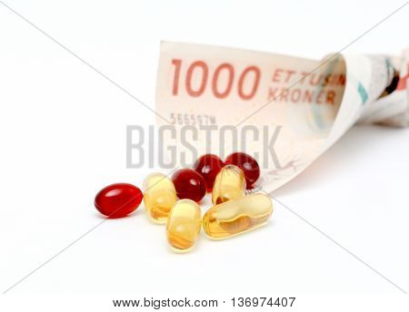 picture of a Cod liver oil omega 3 gel capsules with 1000 danish kroner currency bank note
