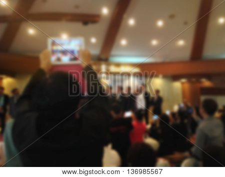 Blurred Background Of Man Recording Video Or Taking Picture By Smartphone