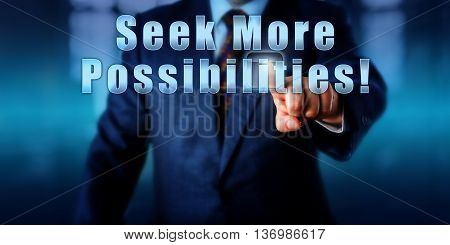 Manager is touching Seek More Possibilities! Motivational metaphor for business development coaching or human resources. Call to action. Torso of man in blue suit over blurred office background.