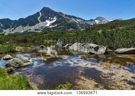Reflection of Sivrya peak in Banski lakes, Pirin Mountain, Bulgaria