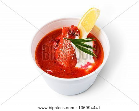 Russian cuisine hot food delivery - borscht soup isolated at white closeup in white plastic plate