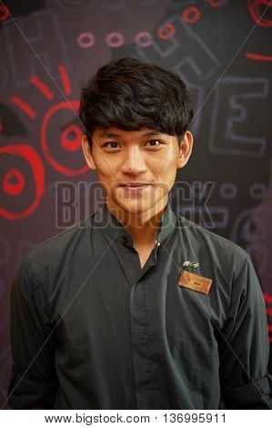 SHENZHEN, CNINA - JUNE 10, 2015: portrait of barista at McCafe. McCafe is a coffee-house-style food and drink chain, owned by McDonald's