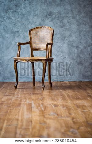 Old Chair On A Gray Wall Background