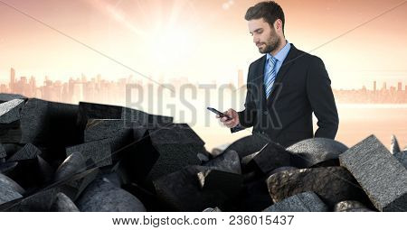 Brokenstone bricks pile and businessman on phone in cityscape
