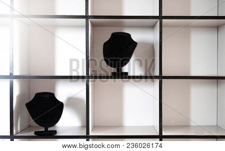 Two Black Necklace Jewelry Display On Grey Box Shelf Fashion Exhibition With Lightbackground
