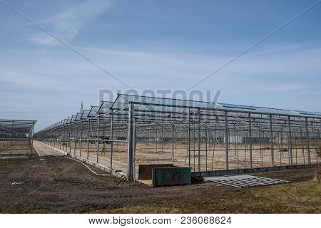 Greenhouse Without Windows Being Demolished On A Spring Day