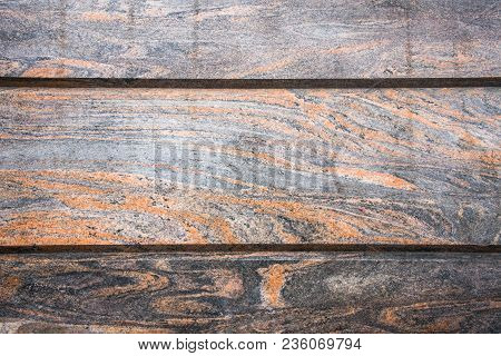 Decorative Facing, Made Of A Gray Polished Stone Plates With A Natural Fancy Ornament Like A Randoml