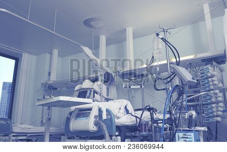 Hospital Room Interior With Sophisticated Electronic Installations And Patient Bed.