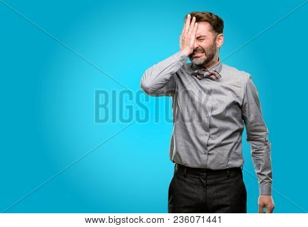 Middle age man, with beard and bow tie stressful keeping hand on head, tired and frustrated