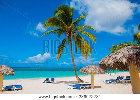 Holguin, Cuba, Playa Esmeralda. Beautiful Caribbean Sea Turquoise Blue Color And Palm Trees On The B