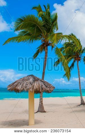 Playa Esmeralda In Holguin, Cuba. Caribbean Sea. Beautiful Paradise Beach: Umbrellas, Sea, Palm Tree