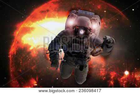 Astronaut In Outer Space With Cheseburger On The Orange Giant Star Background. Elements Of This Imag