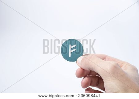 Cryptocurrency Hand Is Holding An Auroracoin In A Composition