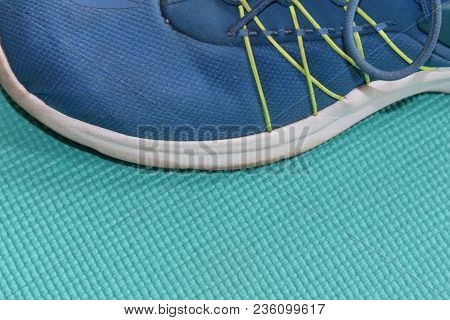 Blue Running Shoe On A Teal Surface