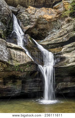 Cedar Falls, A Beautiful Waterfall In The Hocking Hills Of Ohio, Features A Stream Of Water That Spl
