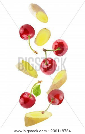 Isolated Flying Fruits. Isolated Falling Cherries And Ginger On White Background With Clipping Path 