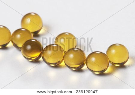 Yellow Capsules Over The Light Background Macro