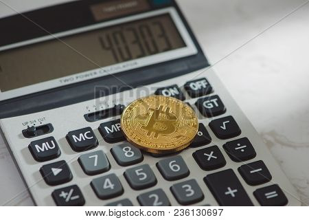 Golden Bitcoin With Calculator On White Background