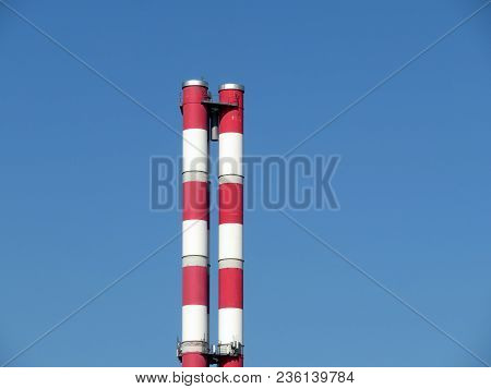 Chp Pipes Against The Clear Blue Sky. Thermal Power Plant Chimney